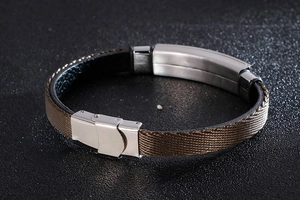 Detail of men's brown silk braided bracelet with a polished silver stainless steel buckle