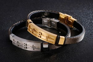 Detail of stainless steel heartbeat pulse engravings on leather couple bracelets