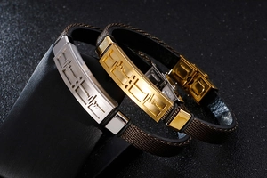 Detail of laser-engraved ECG pattern on stainless steel bracelets with woven leather bands