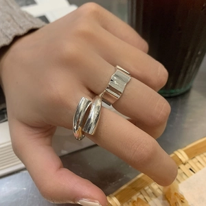 Minimalist silver irregular geometric ring with wavy wide band and overlapping open design