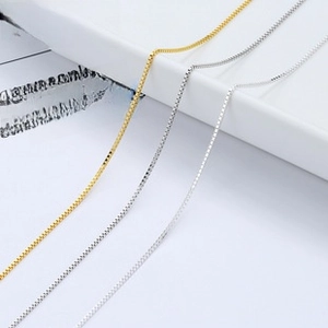 Detailed view of fine S925 sterling silver box chains in gold and silver finishes