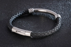 Close-up of black braided leather men's bracelet with silver stainless steel magnetic clasp