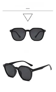 Detail view of black polygon sunglasses with gray lenses and silver metal side accents
