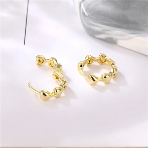 Elegant gold heart-shaped hoop earrings with minimalist smooth finish and metallic shine