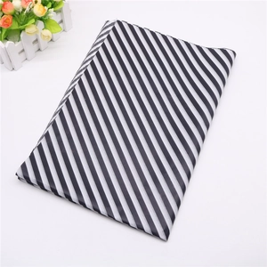 Macro detail of black and white diagonal striped tissue paper for gift wrapping
