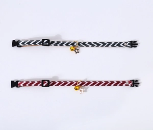Detail view of adjustable daisy pet collars with bell and star charms on white background