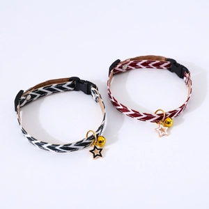 Close-up of woven adjustable pet collars with golden bell and star charm details