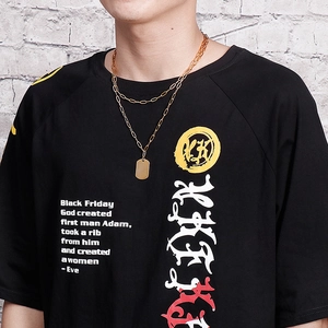 Double layered gold stainless steel necklace with military dog tag on a black logo tee