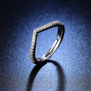 Detail of silver V-shaped wavy ring with shimmering pavé micro-inlaid stones and open design