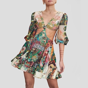 Close-up of vibrant floral print dress with front cutout and circular buckle detail