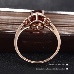 Detailed macro view of 18K rose gold ring setting with red ruby and side diamonds