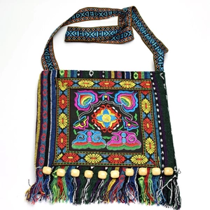 Close-up of colorful floral embroidery and tassels on ethnic crossbody shoulder bag