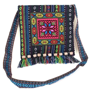 Close-up of Bohemian embroidered bag featuring colorful star patterns and beaded tassels