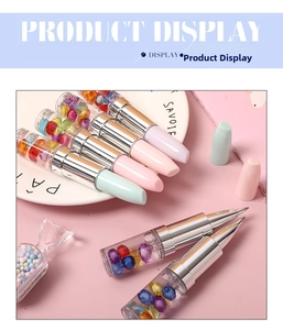 Detail showing lipstick-shaped rollerball pens with gemstone filling and pastel caps