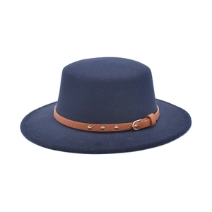 Detail view of navy blue flat top wool fedora with brown leather belt and gold studs