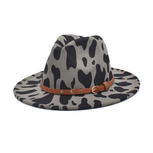 Western fedora hat featuring cow print wool felt and brown studded leather band