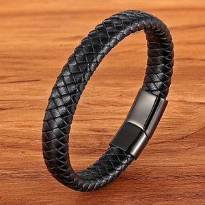 Braided black leather bracelet with black magnetic clasp on a natural wood surface