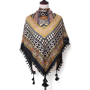 Detail view of Bohemian jacquard square scarf with ethnic geometric patterns and black fringe