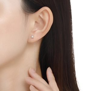 Close-up of minimalist s925 silver threader earring with square stone on female ear