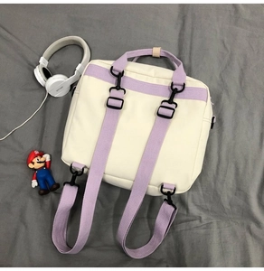 Detail of adjustable purple straps and back view of the beige canvas backpack for students