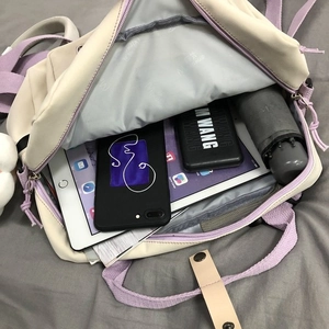 Interior view showing the large storage capacity for tablets and essentials in the canvas bag