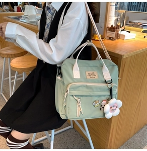 Detailed view of mint green canvas crossbody bag with cute bread and milk embroidery