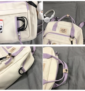 Detailed close-up of canvas bag featuring headphone jack, zippers, and buckle accents