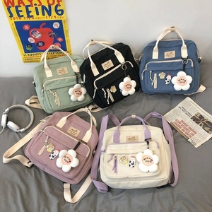 Flat lay of canvas tote bags in black blue green purple and white with headphones