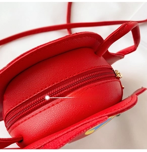 Detail view of the red litchi grain PU leather surface and smooth zipper closure