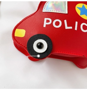 Close-up of red car-shaped children's crossbody bag with POLICE text and star patterns