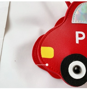 Close-up of red car-shaped PU leather bag with detailed stitching and white letter print
