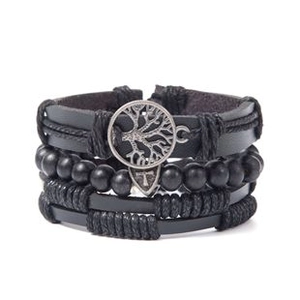 Macro detail of multilayer leather bracelet with tree of life charm and metal rivets