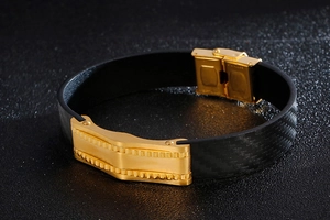 Macro view of black braided leather band with gold stainless steel geometric buckle detail