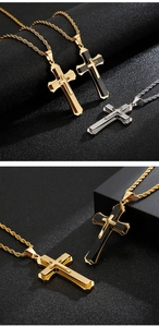 Detailed view of layered cross pendants in gold and silver on a textured twist chain