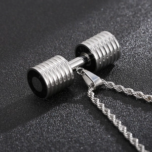 Macro shot of silver titanium dumbbell pendant with textured finish and rope chain