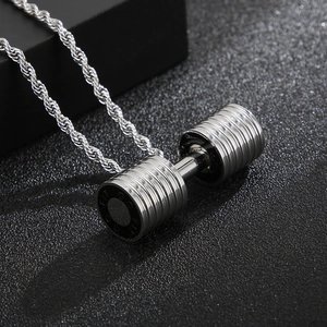 Macro detail of silver barbell pendant with GO FIT engraving on a twist chain necklace