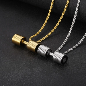 Macro shot of gold and silver dumbbell pendants on braided chains for fitness men