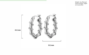 Detail shot of vintage twisted thorn hoop earrings in silver steel with dimensions