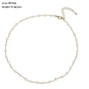 Detail view of oval freshwater pearl necklace with gold-plated lobster clasp and extension