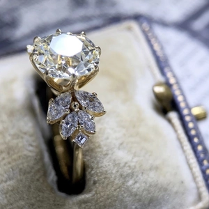 Elegant gold alloy ring with large round zircon and marquise accents in vintage velvet box