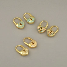 Detail view of heart-shaped lock earrings in gold with colorful rhinestones set