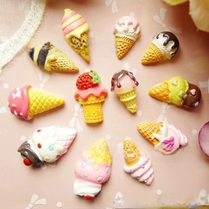 Flat lay of colorful resin bear ice cream charms for DIY phone case and crafts