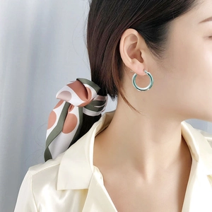 Thick silver stainless steel hoop earrings with a polished finish for a minimalist style