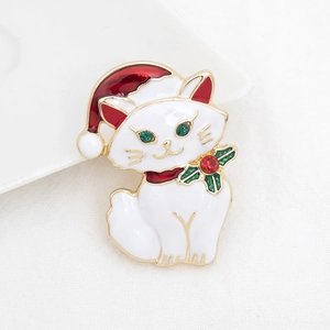Close-up of a Christmas cat brooch with red and green enamel and crystal accents