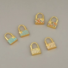 Close-up of golden padlock pendants featuring colorful micro-pave cubic zirconia stones
