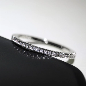 Macro view showing detailed micro-pave cubic zirconia on polished silver eternity ring