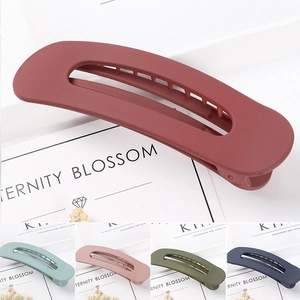 Detail of matte finish large hair clips in five colors including burgundy and navy