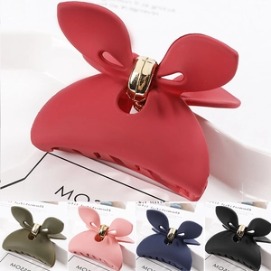 Detail of matte butterfly hair claw clips in five colors including red, green and pink