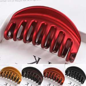 Detail showing various colors of large matte hair claws with geometric cutout design