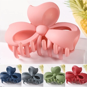 Detailed view of matte texture hair claws in five elegant colors on a clean background